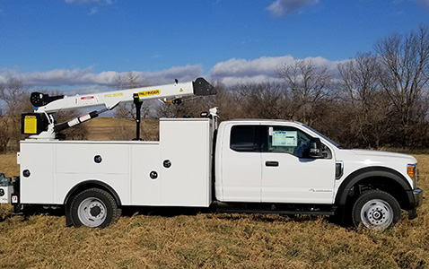 White Work Truck with Boom in Field