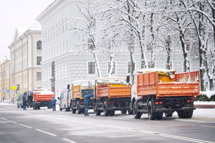 Fleet of Dump Trucks transporting snow